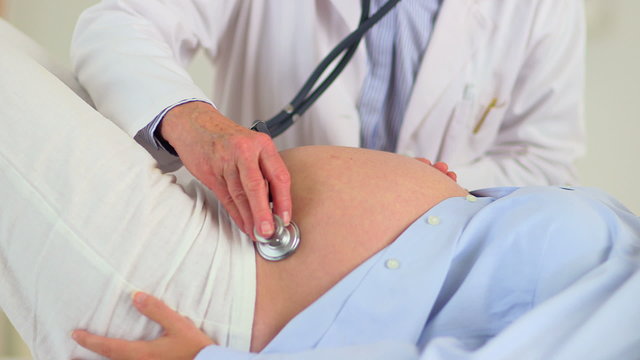 Doctor Examining preganct woman's belly