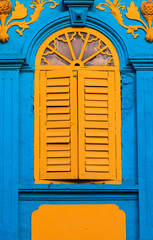 Vintage yellow window on blue wall