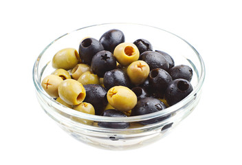 Green and black olives in glass bowl