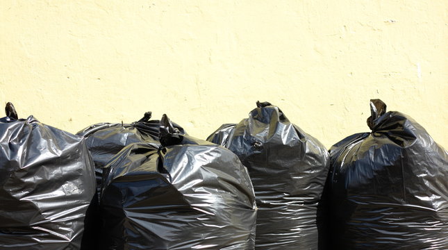 Pile of full black garbage bags