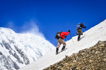 Two mountain trekkers on snow with peaks background - obrazy, fototapety, plakaty