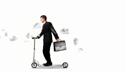 Businessman riding scooter