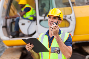 construction foreman talking on walkie-talkie
