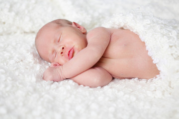 Portrait of  sleeping newborn baby in room