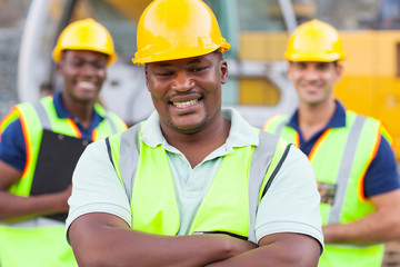 african construction worker with colleagues