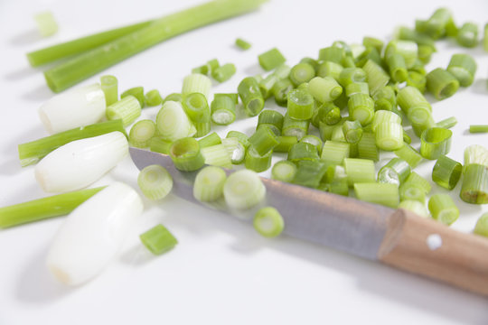 chopped scallions and knife for summer salad