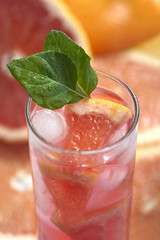 Fresh and cold ice tea with sliced grapefruit and mint