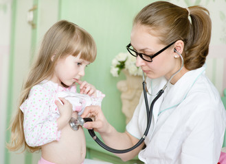 doctor examining girl with stethoscope