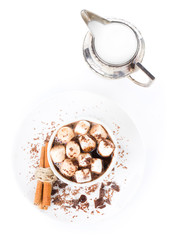 Hot dark chocolate with mini marshmallow, cinnamon and milk in a