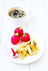 Breakfast with fried cutted egg, black coffee and vegetables on