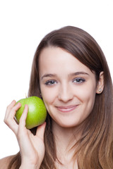 Beautiful brunette holding green apple.