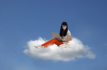 Beautiful female sitting with laptop on cloud