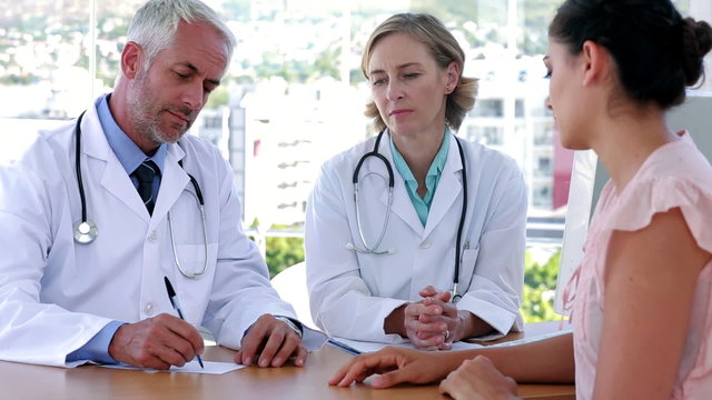 Doctors explaining something to patient