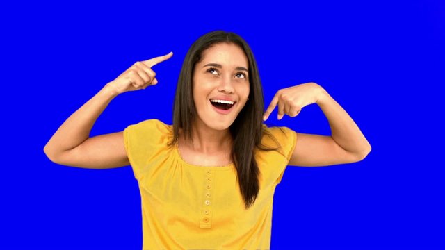 Woman making crazy gesture on blue screen