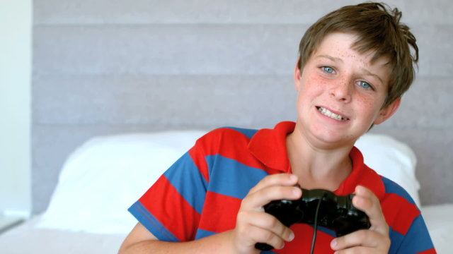 Concentrated young boy playing video games