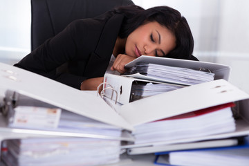 Businesswoman Sleeping On Piles Of Folders
