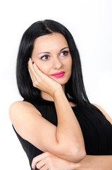 Fototapeta premium Beautiful brunette posing with one hand to her face