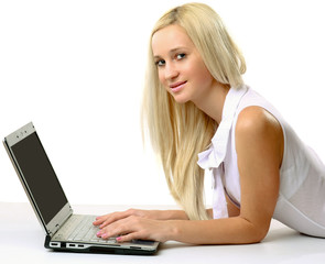 businesswoman lying on the floor and working on a laptop.