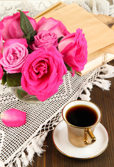 Beautiful pink roses in vase on wooden table close-up