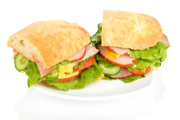Sliced sandwich with ham and vegetables isolated on white