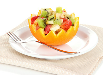 Fruit salad in hollowed-out orange isolated on white