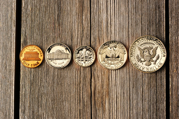 US cent coins over wooden background