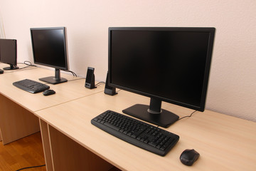 Computers on tables in room