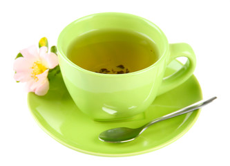 Cup of herbal tea with hip rose flower, isolated on white