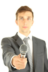 Young businessman talking with microphone, isolated on white