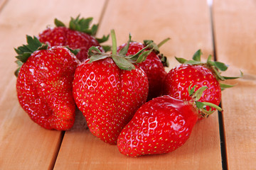 Many strawberries on wooden table