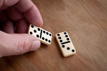 Hand with domino.