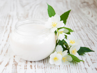 Fototapeta na wymiar face cream with jasmine flowers