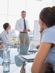 Fototapeta premium Businessman standing in front of colleagues