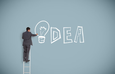Buisnessman on ladder writing idea
