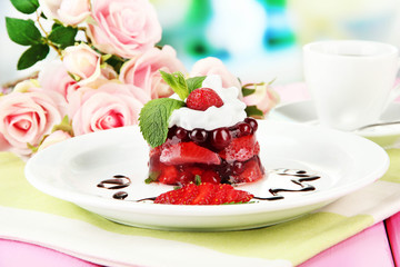 Tasty jelly dessert with fresh berries, on bright background