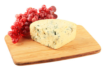 Tasty blue cheese and grape on cutting board, isolated on white
