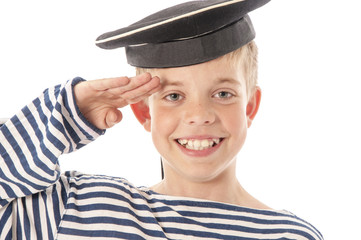 Little sailor in the sea cap salutes