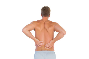 Fototapeta premium Shirtless man suffering from lower back pain