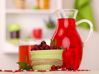 Pitcher and glass of cranberry juice with red cranberries