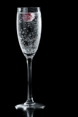 clear champagne with a raspberry