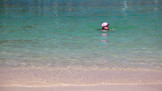 Young girl swimming in sea, summer vacation time