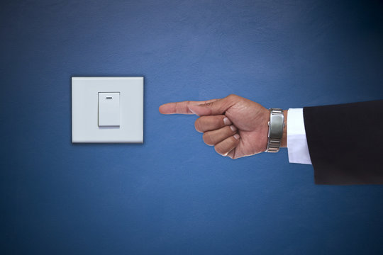 hand pointing to switch of electric appliance