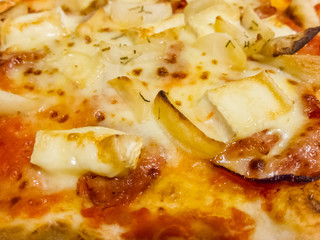 Melted golden cheese on Italian pasta