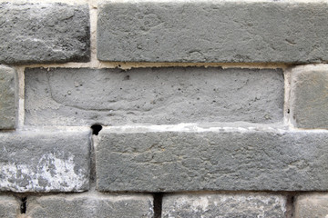 Broken gray brick wall in rural