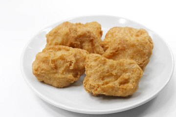 chicken nuggets food on white plate