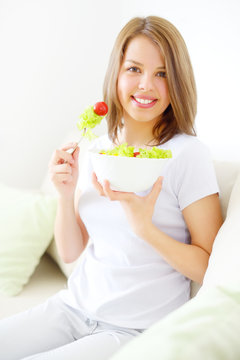 Teenager girl eating salad