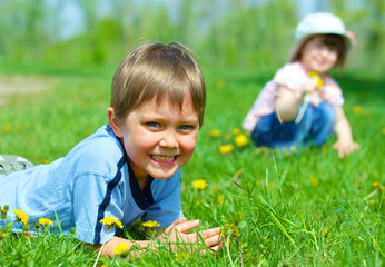 girl sitting among dandelions