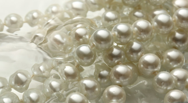 Shining string of white pearl in water