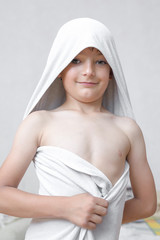 Smiling little boy in towel