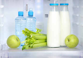 Open refrigerator with vegetarian food